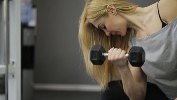 Chica haciendo ejercicio con mancuernas
